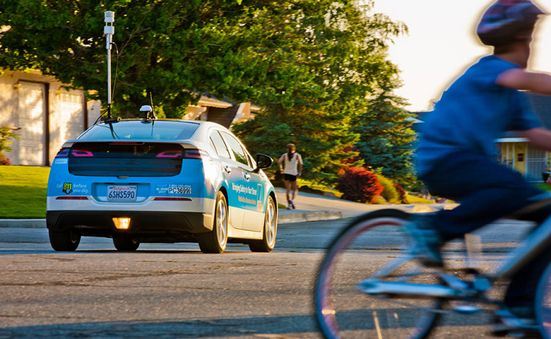 An electric car; cyclist in the foreground